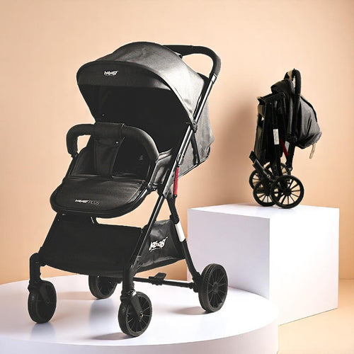 Black stroller on a white platform with a beige background